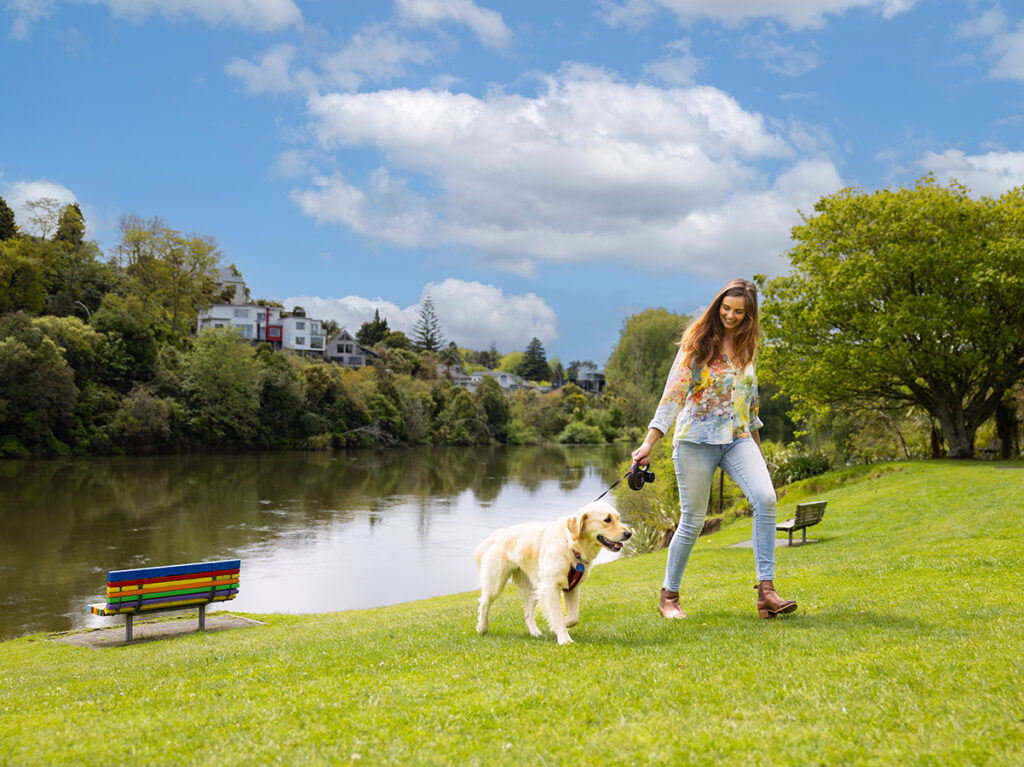 Bri and dog Marlie walking by the Waikato River